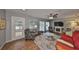 Relaxing living room with a TV, comfy seating, and wood-look tile floors at 1807 Pineapple Palm Ct, Sun City Center, FL 33573