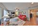 Living area with hardwood floors, red couch, and a fireplace at 1807 Pineapple Palm Ct, Sun City Center, FL 33573