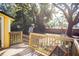 Deck and fenced backyard with mature trees at 1913 E Wilder Ave, Tampa, FL 33610