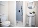 Updated bathroom featuring a shower and pedestal sink at 1913 E Wilder Ave, Tampa, FL 33610