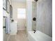 Updated bathroom with a tub, shower, and modern vanity at 1913 E Wilder Ave, Tampa, FL 33610