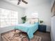 Bright bedroom with a light teal comforter and a ceiling fan at 1913 E Wilder Ave, Tampa, FL 33610