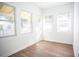 Bright, airy room featuring hardwood floors and abundant natural light through multiple windows at 1913 E Wilder Ave, Tampa, FL 33610