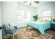 Spacious bedroom with light teal bedding and wood-look floors at 1913 E Wilder Ave, Tampa, FL 33610