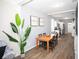 Dining room with wood table, four chairs, and kitchen view at 1913 E Wilder Ave, Tampa, FL 33610