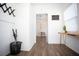 Well-lit entryway with wood-look floors and coat rack at 1913 E Wilder Ave, Tampa, FL 33610