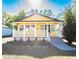 Inviting yellow house with white porch and steps leading to the entrance at 1913 E Wilder Ave, Tampa, FL 33610