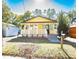 Charming yellow house with white porch and landscaped lawn at 1913 E Wilder Ave, Tampa, FL 33610