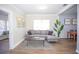 Living room featuring L-shaped sofa and wood floors at 1913 E Wilder Ave, Tampa, FL 33610