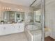 Bathroom features a large soaking tub, double vanity, and walk-in shower at 2001 Longliner Loop, Wesley Chapel, FL 33543