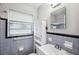 Updated bathroom with a white vanity and purple tile at 218 W Seneca Ave, Tampa, FL 33612