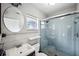 Bathroom with a walk-in shower and round mirror at 218 W Seneca Ave, Tampa, FL 33612