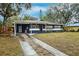 Cute Ranch style home with updated exterior paint and landscaping at 218 W Seneca Ave, Tampa, FL 33612