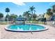 Community pool with lounge chairs and tropical landscaping at 2424 W Tampa Bay Blvd # C212, Tampa, FL 33607