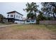 Two-story house and smaller bungalow with carport, fenced yard, and large tree at 2480 18Th N Ave, St Petersburg, FL 33713