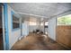 Enclosed porch with wooden floors, white walls, and a window at 2480 18Th N Ave, St Petersburg, FL 33713