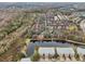 Aerial view of a community with lake, lush landscaping, and townhouses at 2552 Glenrise Pl, Wesley Chapel, FL 33544