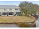 Back of house with screened porch and canal view at 2552 Glenrise Pl, Wesley Chapel, FL 33544