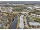 Aerial view showing townhouses, a lake, roads, and nearby businesses at 2552 Glenrise Pl, Wesley Chapel, FL 33544