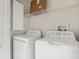 Laundry room with washer, dryer, and shelving at 2552 Glenrise Pl, Wesley Chapel, FL 33544