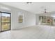 Living room with doors leading to a patio and pond view at 2552 Glenrise Pl, Wesley Chapel, FL 33544