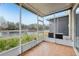 Screened porch with canal view and tile floor at 2552 Glenrise Pl, Wesley Chapel, FL 33544