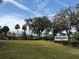 Highland Lakes Club entrance with flag and landscaping at 3115 Mission Grove Dr, Palm Harbor, FL 34684