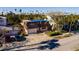 Two-story house with a tarp on the roof, situated on a residential street at 3118 S Maritana Dr, St Pete Beach, FL 33706