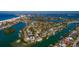 Aerial view of waterfront home with private dock and boat at 3118 S Maritana Dr, St Pete Beach, FL 33706