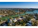 Aerial view of waterfront home with pool and private dock, showcasing the surrounding neighborhood at 3118 S Maritana Dr, St Pete Beach, FL 33706