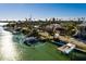 Aerial view showcasing waterfront home, boat dock, and neighboring houses at 3118 S Maritana Dr, St Pete Beach, FL 33706