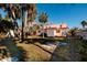 Large backyard with lush grass and mature palm trees at 3118 S Maritana Dr, St Pete Beach, FL 33706