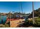 Wooden dock with sailboat and blue chair, offering waterfront access at 3118 S Maritana Dr, St Pete Beach, FL 33706