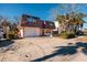 Two-story house with attached garage, and a red door at 3118 S Maritana Dr, St Pete Beach, FL 33706