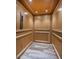 Private home elevator with wood paneling at 335 Bath Club S Blvd, North Redington Beach, FL 33708