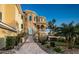 Impressive three-story home with stone accents, balconies, and landscaped grounds at 335 Bath Club S Blvd, North Redington Beach, FL 33708