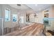 Open and bright hallway with hardwood floors and modern light fixture at 335 Bath Club S Blvd, North Redington Beach, FL 33708