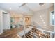 Modern open concept hallway with glass railings and chandelier at 335 Bath Club S Blvd, North Redington Beach, FL 33708