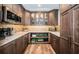 Well-appointed kitchen pantry with granite countertops and glass-front cabinets at 335 Bath Club S Blvd, North Redington Beach, FL 33708