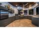 Modern outdoor kitchen with dark gray cabinetry, stainless steel appliances, and a large island at 335 Bath Club S Blvd, North Redington Beach, FL 33708