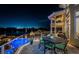 Night view of waterfront patio with seating and pool at 335 Bath Club S Blvd, North Redington Beach, FL 33708