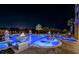 Expansive pool and spa with fire features at night at 335 Bath Club S Blvd, North Redington Beach, FL 33708