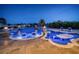 Night view of a luxurious pool and spa with fire bowls at 335 Bath Club S Blvd, North Redington Beach, FL 33708