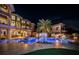 Night view of a luxurious pool and spa with fire bowls at 335 Bath Club S Blvd, North Redington Beach, FL 33708