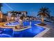 Stunning pool and spa at night with blue lighting at 335 Bath Club S Blvd, North Redington Beach, FL 33708