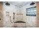 Large walk-in shower with dual shower heads and pebble floor at 335 Bath Club S Blvd, North Redington Beach, FL 33708