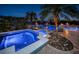 Relaxing spa with blue lighting nestled in a tropical landscape at 335 Bath Club S Blvd, North Redington Beach, FL 33708