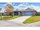 Attractive single-story home with a landscaped lawn and a two-car garage at 3745 Hillview Ct, Land O Lakes, FL 34639