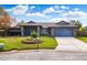 Beautiful ranch home with a two-car garage and well-manicured lawn at 3745 Hillview Ct, Land O Lakes, FL 34639