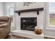 White brick fireplace with a dark wooden mantel at 3745 Hillview Ct, Land O Lakes, FL 34639